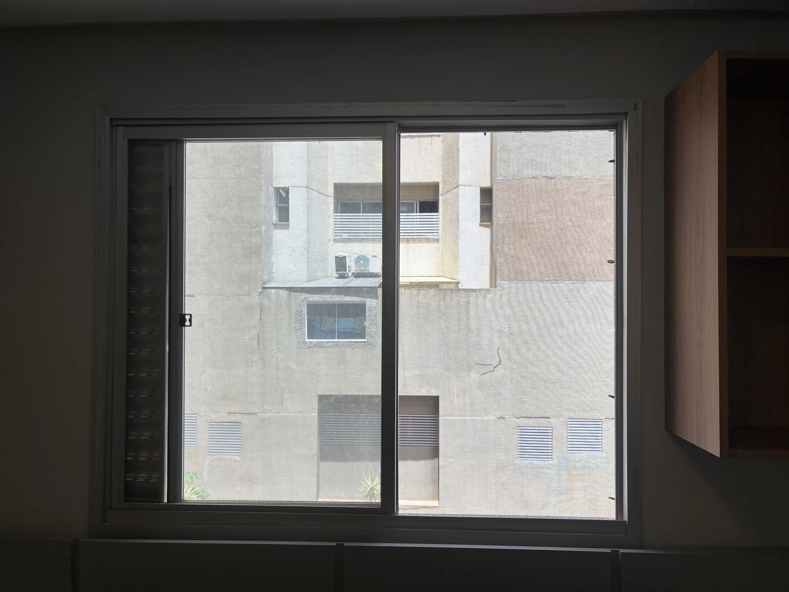 Janela com tela mosquiteira e acabamento natural dos perfis no Edifício Osório de Moraes, Rua 8 Norte, Lote 1, Águas Claras